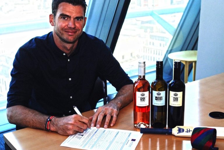 Jimmy Anderson, with bottles from the Numbers Collection, signing his Lord's Taverners membership form copy